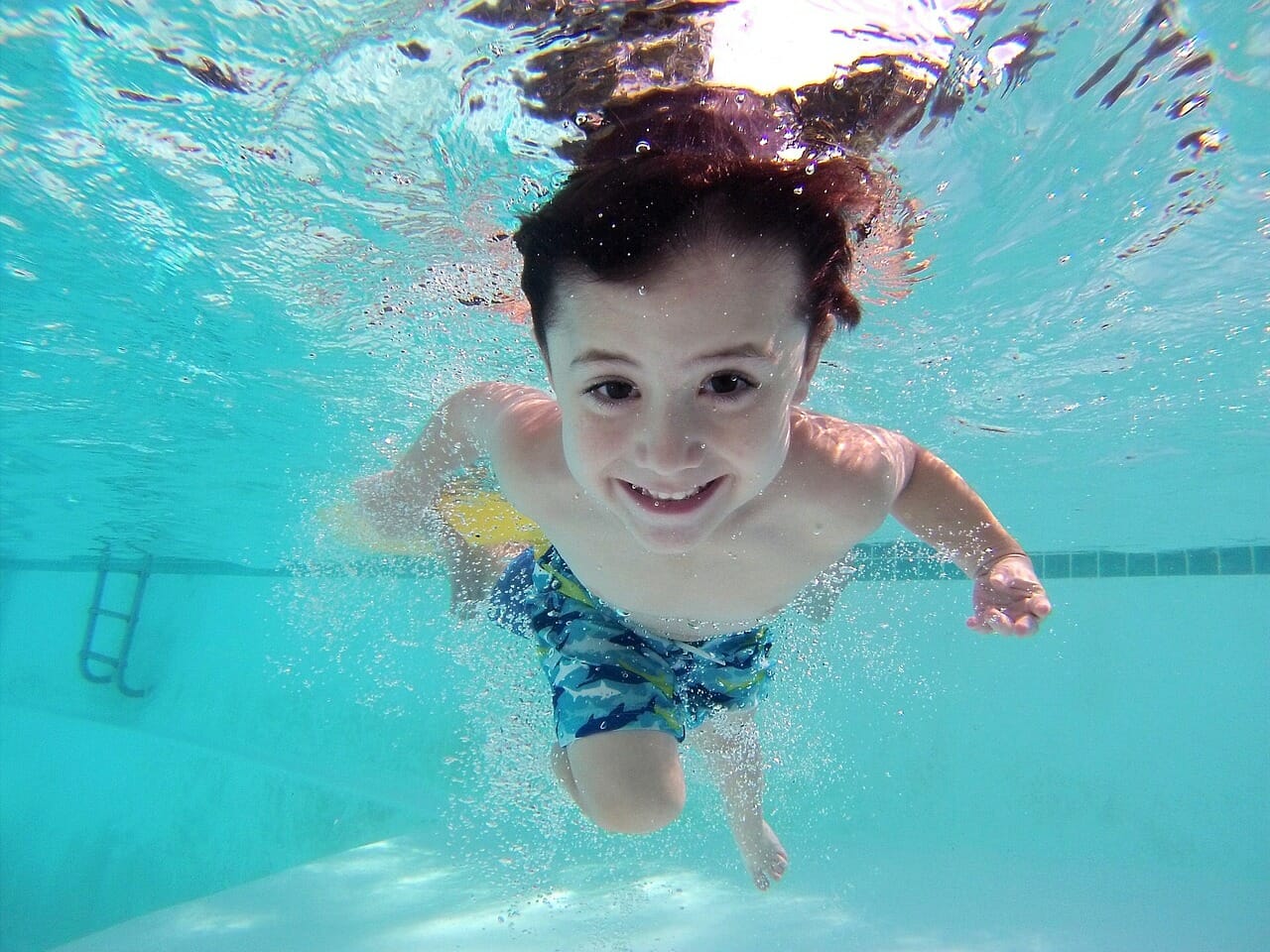 boy swimming under water